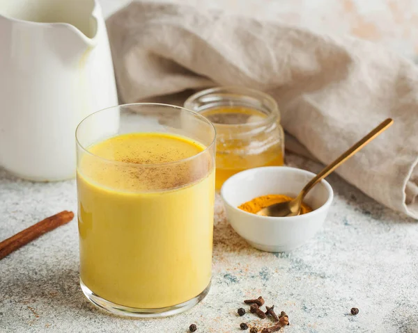 Moon milk for better sleep. Turmeric Golden milk with cinnamon, honey. A trendy relaxing drink before going to bed. Ayurvedic drink. High quality photo