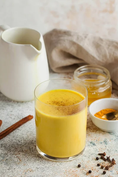 Moon milk for better sleep. Turmeric Golden milk with cinnamon, honey. A trendy relaxing drink before going to bed. Ayurvedic drink. High quality photo