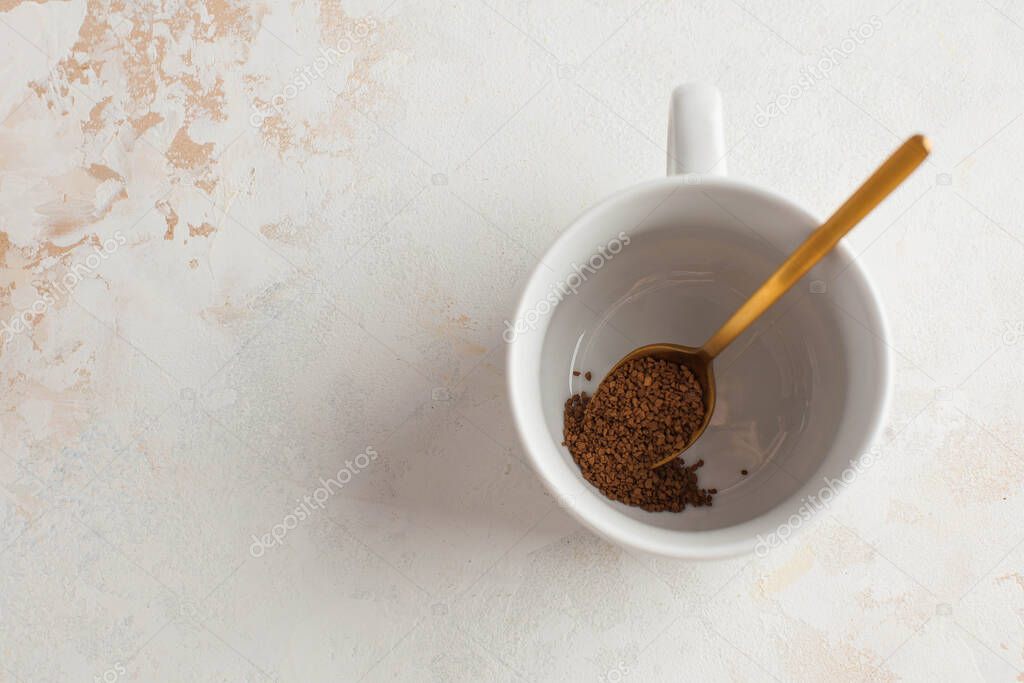 Instant coffee in a Golden spoon. Concept of instant coffee birthday celebration. Copy space. High quality photo