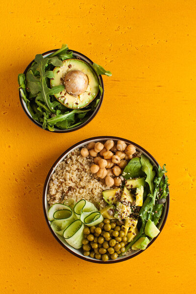 Healthy vegetable lunch from the Buddha bowl with quinoa, avocado, chickpeas, cucumber. The concept of a healthy food dish for vegetarians, a trend dish. High quality photo