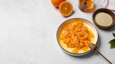 İçinde dilimlenmiş balkabağı, bal ve portakal suyu olan sağlıklı bir tatlı. Sağlıklı balkabağı yemeği kavramı. Boşluğu kopyala