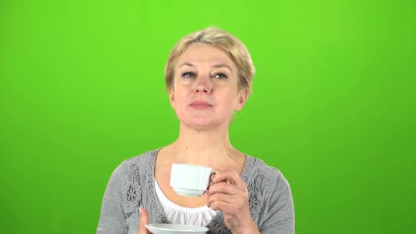 Woman is drinking tea. Green screen — Stock Video