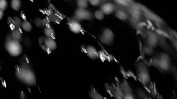 Belle éclaboussure d'eau. Débit d'eau clair à la surface. Mouvement lent gros plan noir .