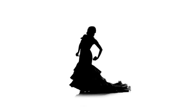 Vrouw is castagnetten in haar handen dansen dansen. Witte achtergrond. Silhouet — Stockvideo