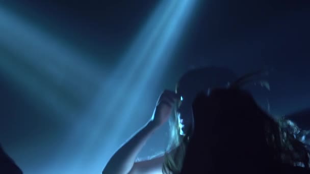 Teenager zu Musik, die Hände in den Nachtclub springen. Silhouette. Zeitlupe — Stockvideo