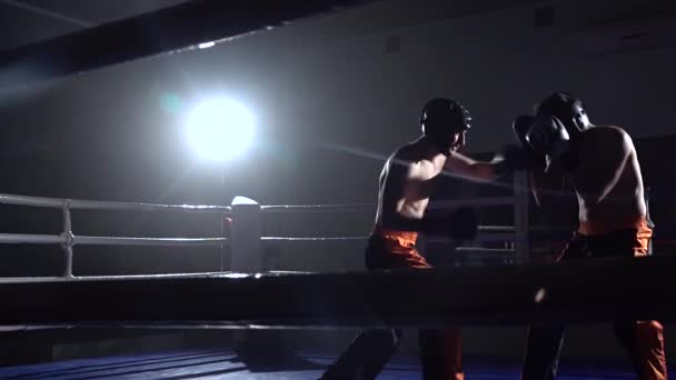 Zwei Jungs im Ring kämpfen im Dunkeln. Zeitlupe — Stockvideo