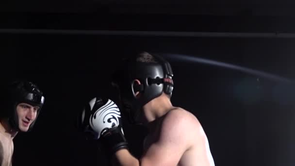Two guys preparing for kickboxing competitions. Slow motion. Silhouette — Stock Video