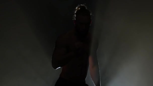 Man is dancing a strip. Black background. Silhouette — Stock Video