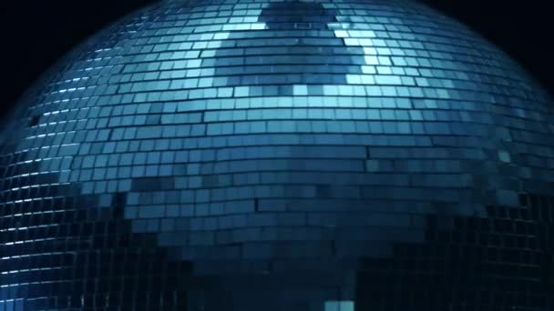 Mirror disco ball close up in the center of a spin on a black background — Stock Video