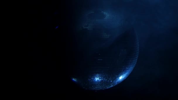 Shiny disco ball rotating around on smoke black background . Close up — Stock Video