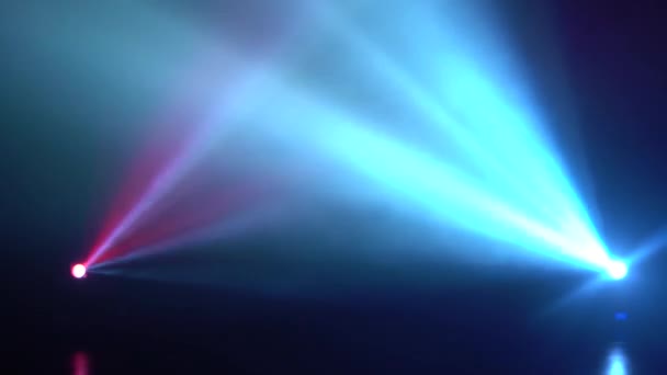 Multicolored streams of light unite in a single on a black background — Stock Video