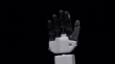 Robot el yakın bye sallıyor. Siyah arka plan. Yakın çekim. Ağır çekim