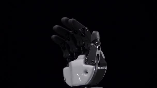 Roboterhand in Großaufnahme winkt zum Abschied. schwarzer Hintergrund. Nahaufnahme. Zeitlupe — Stockvideo