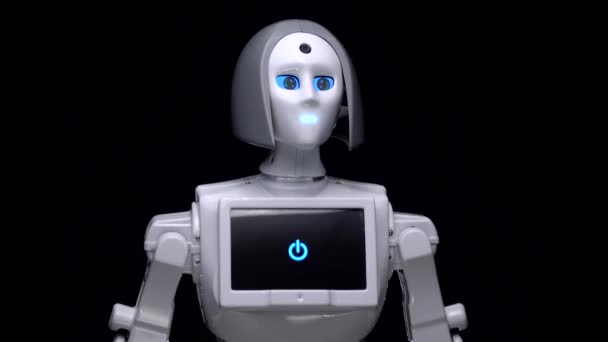 Robot leans forward. Black background. Close up — Stock Video