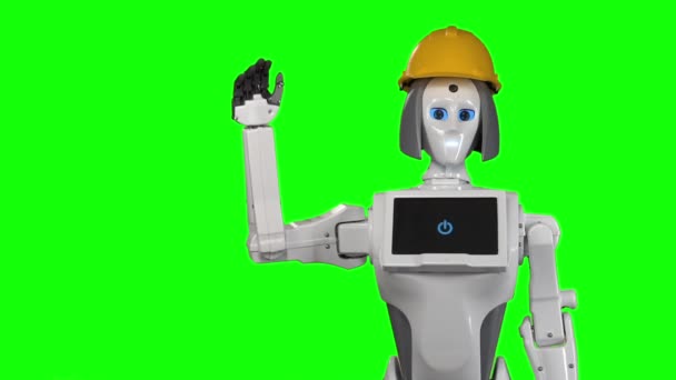 Robô em um capacete de construtores laranja acena adeus. Tela verde. Movimento lento — Vídeo de Stock