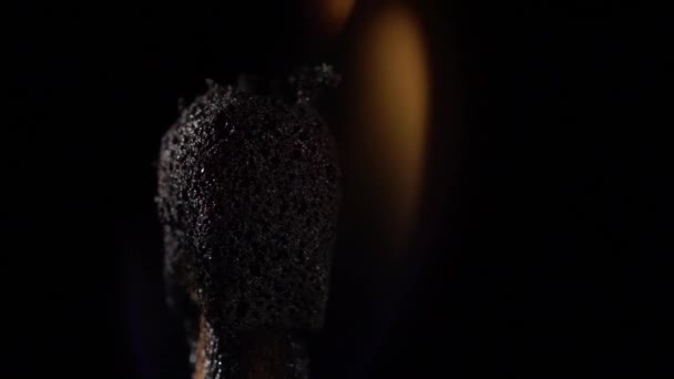 Match instantly lights up and goes out. Slow motion. Black background. Close up — Stock Video