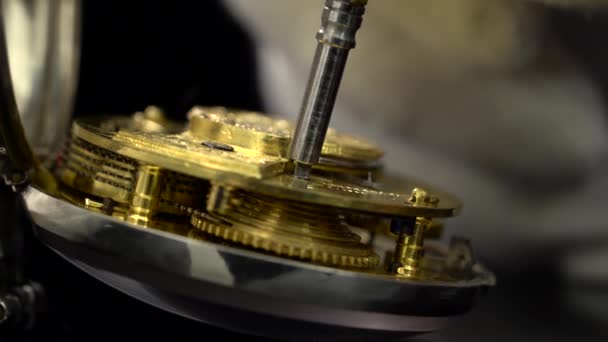 Den alten Schlüsselmechanismus der Uhr aufziehen. Nahaufnahme. schwarzer Hintergrund. Klang — Stockvideo