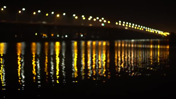 Defocus view of the river and the bridge for moving cars — Stock Video