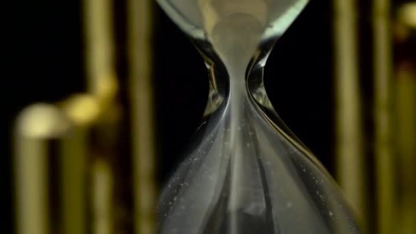 Hourglass turn over. Close up. Black background — Stock Video