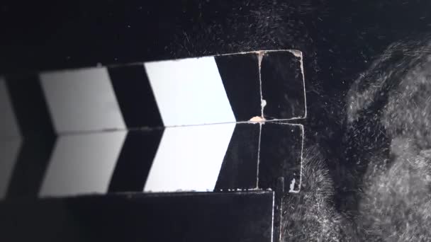 Movie clapboard action . Close up. Black background — Stock Video