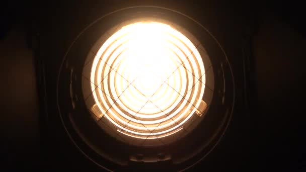 Fresnel spotlight illuminates and switches off. Black background. — Stock Video