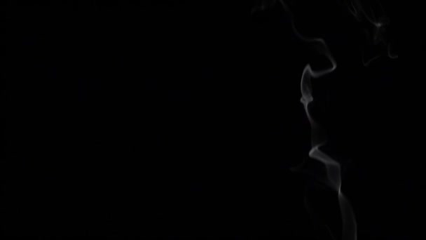 Smoke billowing over a black background. Slow motion — Stock Video