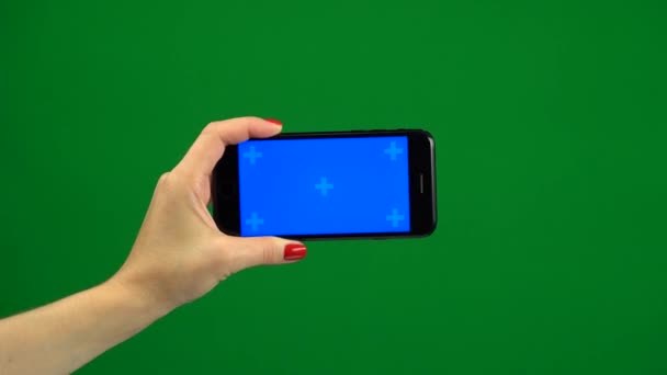 Phone screen is blue chroma key. Green screen — Stock Video