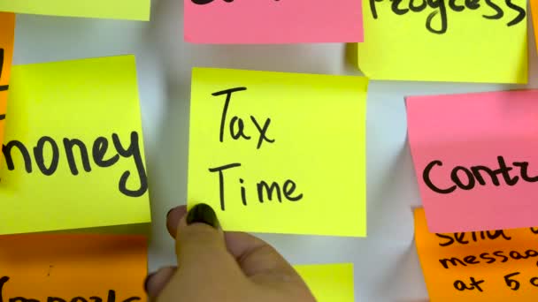 Sticker with the words tax time on a whiteboard — Stock Video