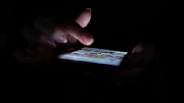 Close up woman uses app on the phone on the black background — Stock Video