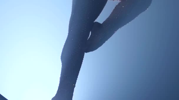 Graceful gymnast performs tricks on a special design moon in a dark room. Black smoke background. Slow motion. Close up — Stock Video