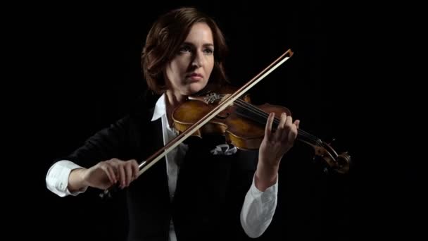 Girl in play the violins in a room. Black background — Stock Video