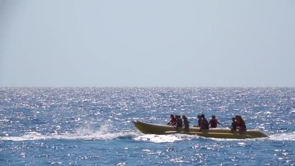 Toeristen rijden bananen boot water sport activiteiten. Slow motion — Stockvideo