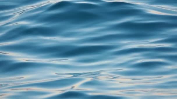 Primer plano de la superficie perturbada del agua del océano azul. Movimiento lento — Vídeo de stock