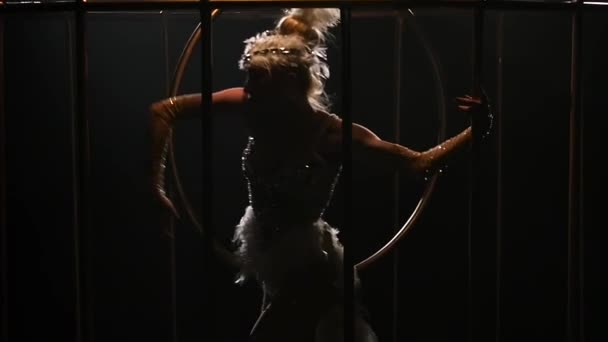 Gymnast a spinning on a hoop in a gold cage. Black background. Slow motion. Close up — Stock Video