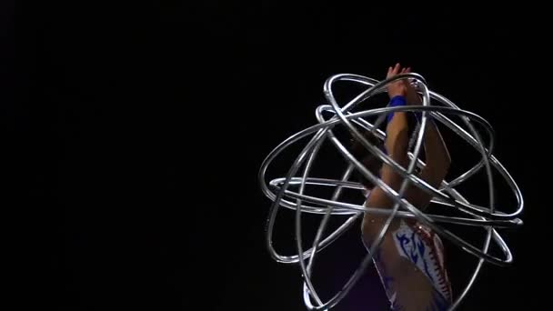 Actress holds hoops in her hands . Black background. Slow motion — Stock Video