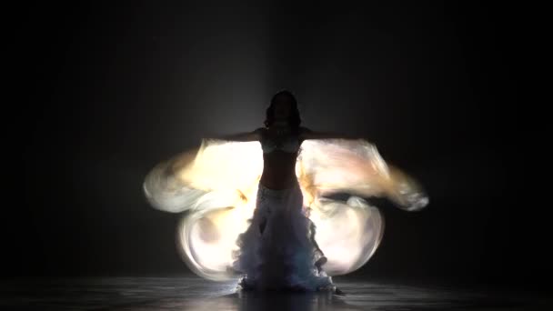 Girl dancer in lace dress hands wings. Smoke background. Sihouette — Stock Video