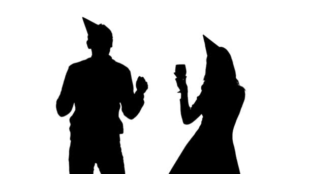 Couple dancing and drinking from glasses a party to the birthday. White background. Silhouette — Stock Video