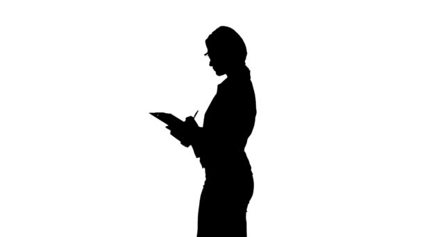 Attractive business woman writes them down on paper. White background. Side view. Silhouette — Stock Video