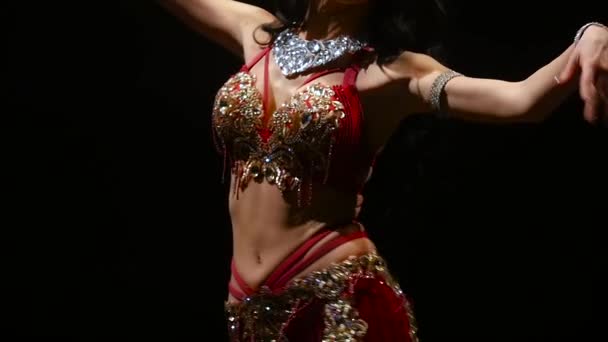 Girl performs belly dance in oriental costume. Black background. Slow motion. Close up — Stock Video
