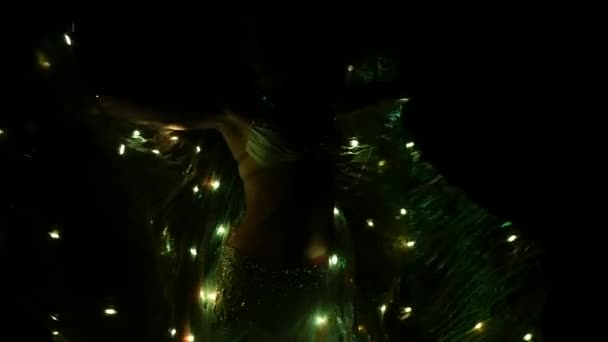 Dancer in a costume with bright lanterns spinning. Black background. Sihouette. Slow motion — Stock Video