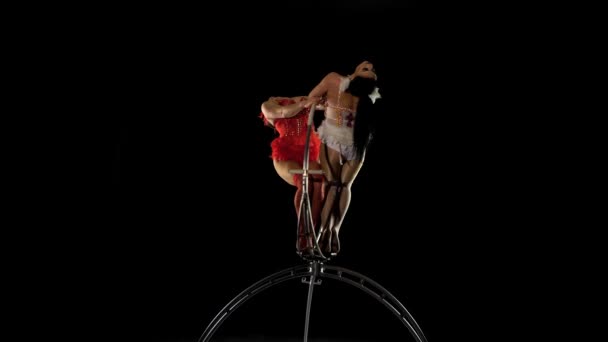 Gymnasts spin and perform various stunts on the stage. Black background — Stock Video