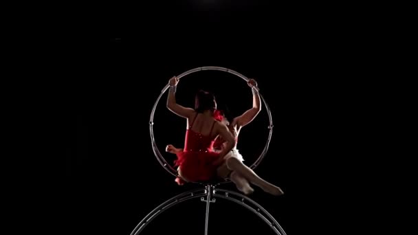 Gymnasts performs a trick in the aerial hoop. Black background. Slow motion — Stock Video