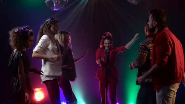 クラブレトロ音楽コンサートの女の子が踊る人々の周りに歌います。煙の背景。スローモーション — ストック動画