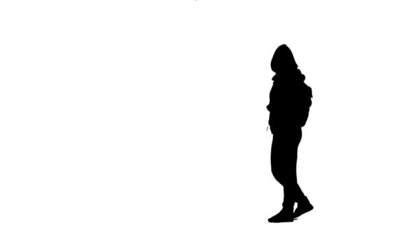 Girl walking taking a photo and selfie. Silhouette. White background. Side view — Stock Video