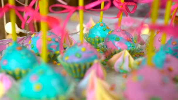 Modern childrens birthday party. Unicorn themed treats, close-up against colorful background. — Stock Video