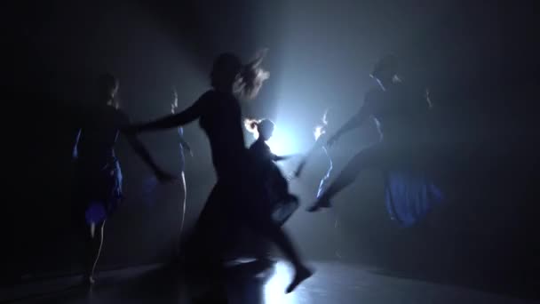 Silhouettes of beautiful slim figures dancing on black background, studio — Stock Video
