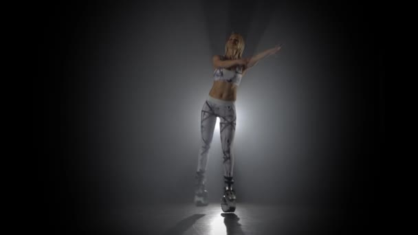 Female doing exercises in kangoo jumps at studio with haze — Stock Video