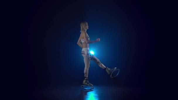 Pretty girl in sports suit dancing in kangoo jumps shoes. — Stock Video