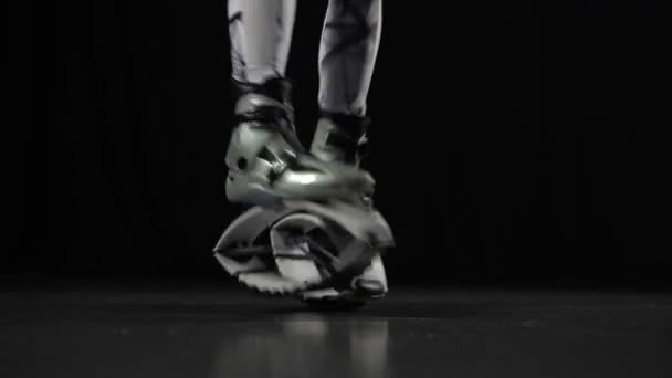 Close-up motion of trainers legs performing in kangoo jumps shoes. — Stock Video