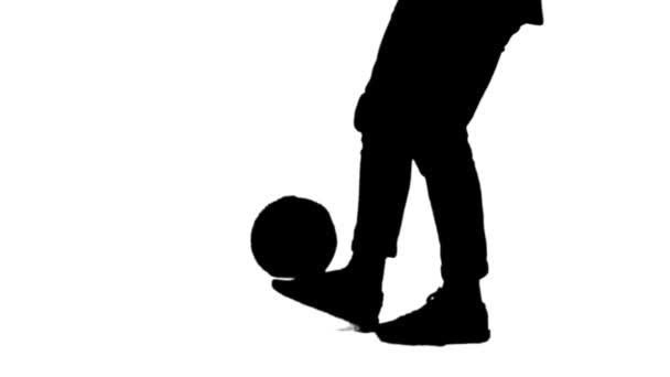 Czarna sylwetka człowieka nadziewana piłka do piłki nożnej na nogę. — Wideo stockowe